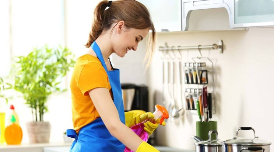 a woman from kitchen cleaning services is cleaning kitchen